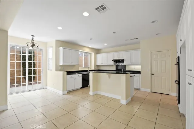 a kitchen with stainless steel appliances a refrigerator sink and microwave