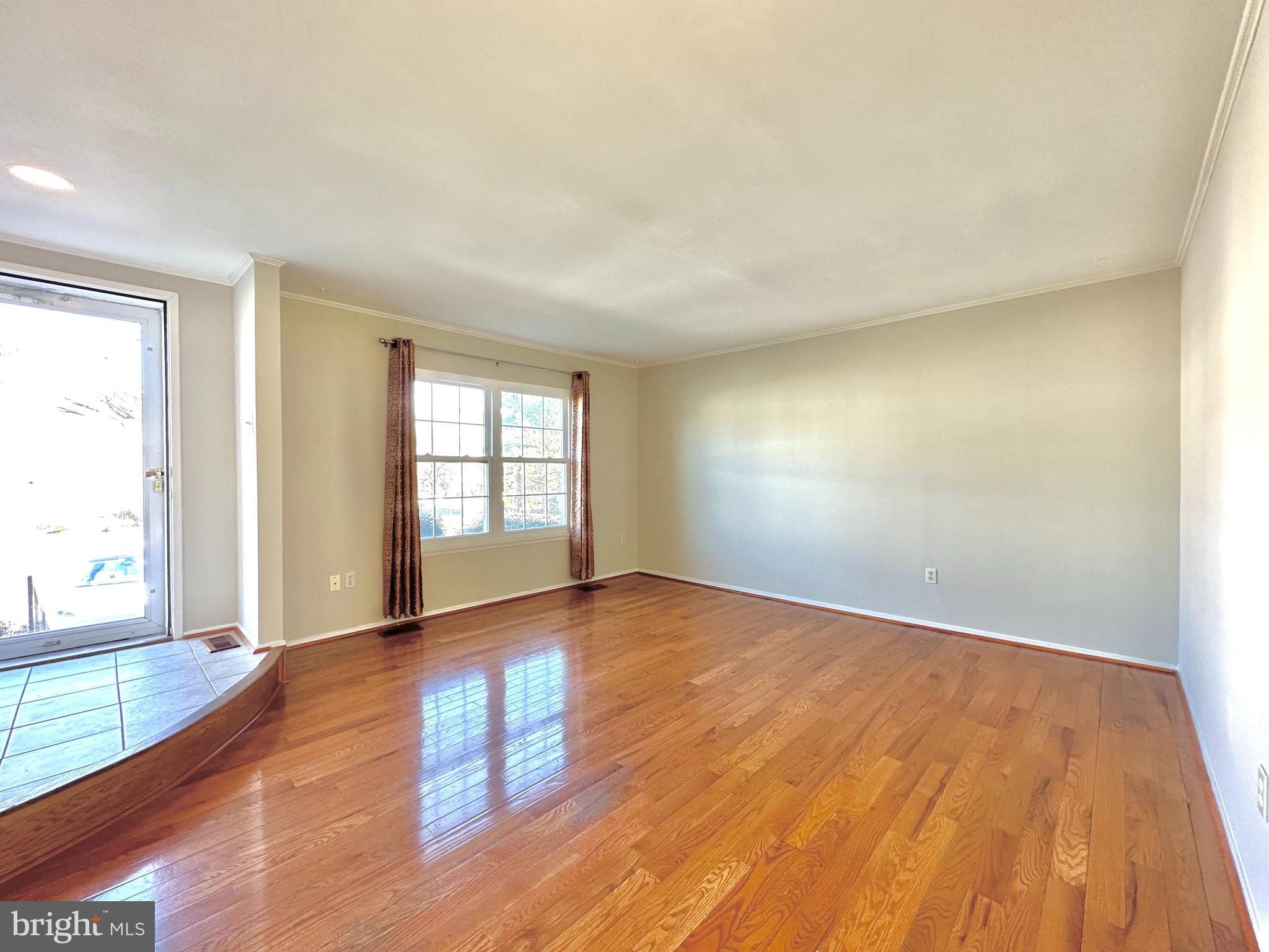 402 Carousel Court Gaithersburg, MD 20877 - Photo 8 of 29 a view of empty room with wooden floor and fan