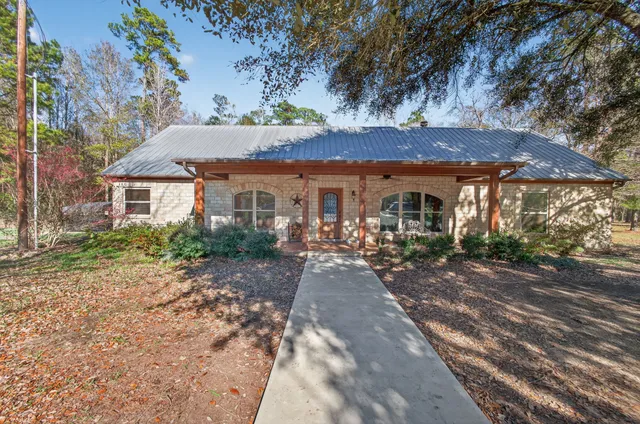 a view of a patio with a table and chairs under an umbrella
