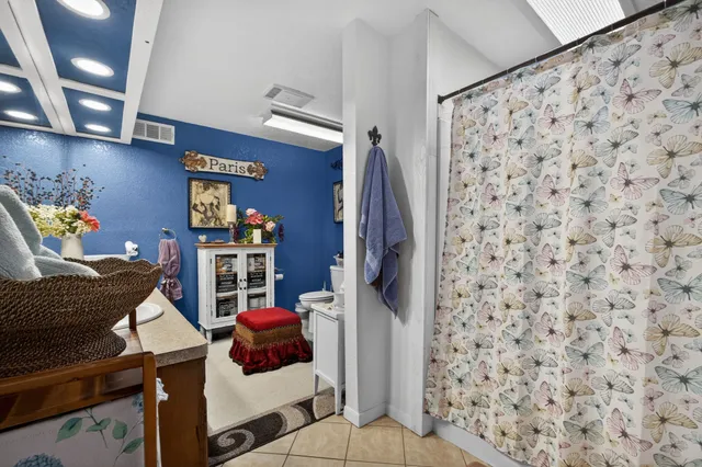 a living room with furniture and a lamp