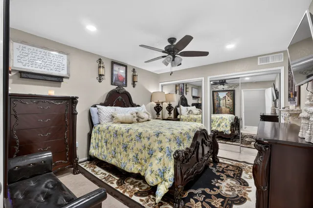 a bed room with a bed mirror and a window