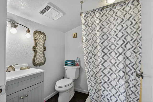 a bathroom with a toilet and a sink