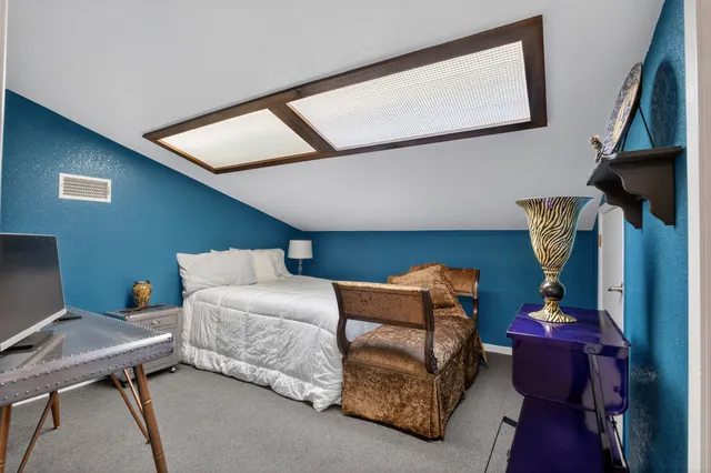 a bedroom with furniture and a window