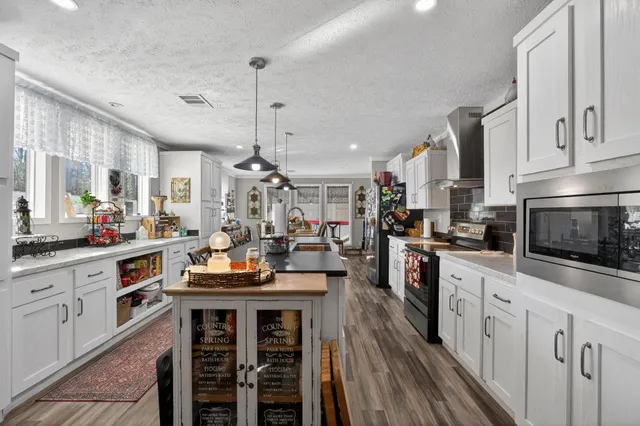 a kitchen with counter top space appliances and cabinets