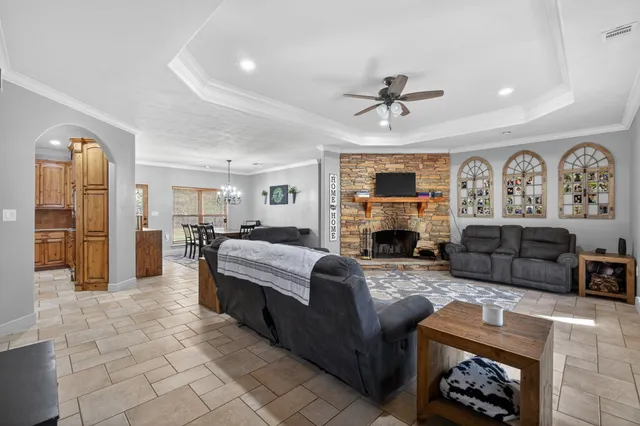 a living room with furniture a fireplace and a flat screen tv