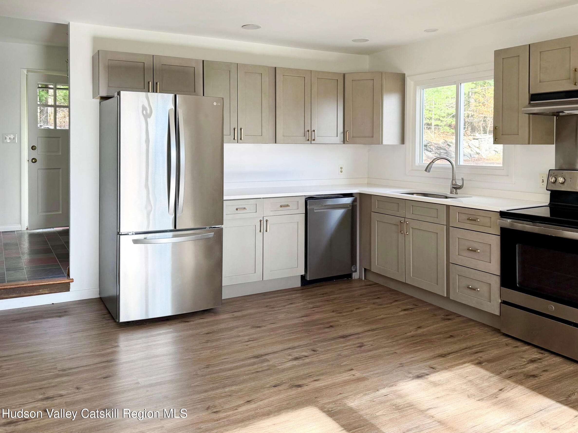 13 Heyden Road Shokan, NY 12481 - Photo 16 of 37 a kitchen with wooden floors and stainless steel appliances