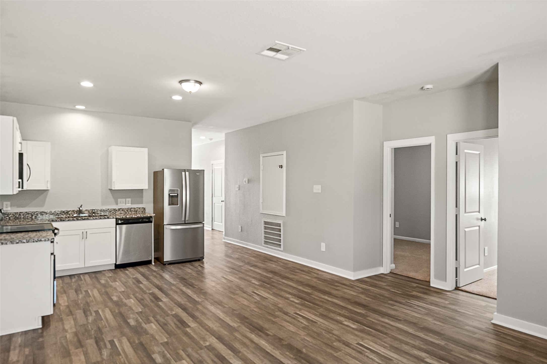 2537 18th Street Hempstead, TX 77445 - Photo 27 of 28 Wide interior view showcasing the open floor plan connecting the kitchen, dining, and living spaces.