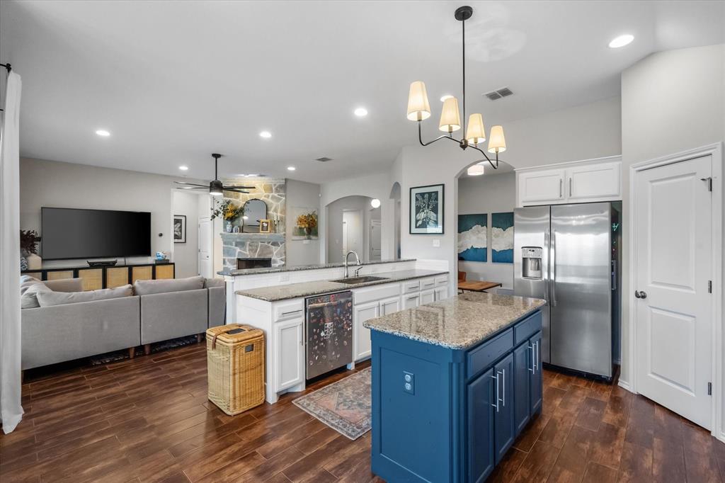 7224 Prestwick Terrace Benbrook, TX 76126 - Photo 15 of 39 a kitchen with stainless steel appliances granite countertop a refrigerator a sink dishwasher a oven and a dining table with wooden floor