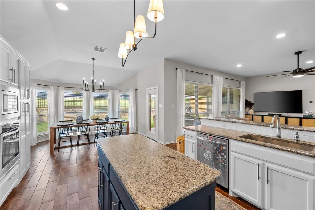 7224 Prestwick Terrace Benbrook, TX 76126 - Photo 16 of 39 a large kitchen with kitchen island a sink table and chairs