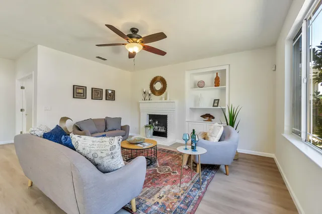 a living room with furniture and a fireplace
