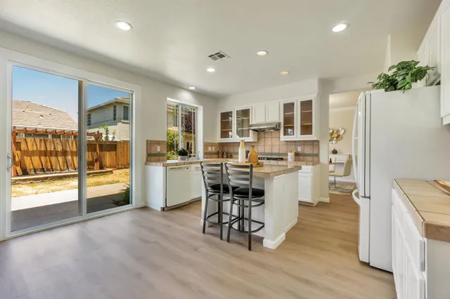 a kitchen with a sink a counter top stainless steel appliances and cabinets