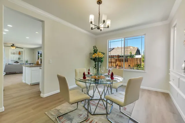 a view of a dining room with furniture wooden floor and a chandelier