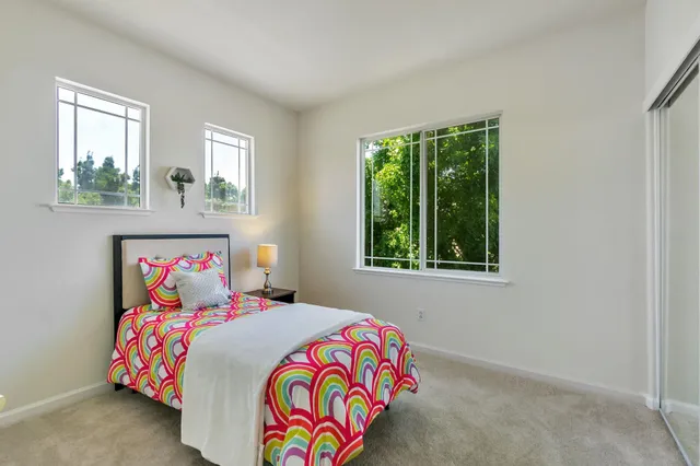 a bedroom with a bed and a lamp on table