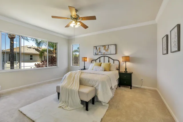 a bedroom with a bed and ceiling fan