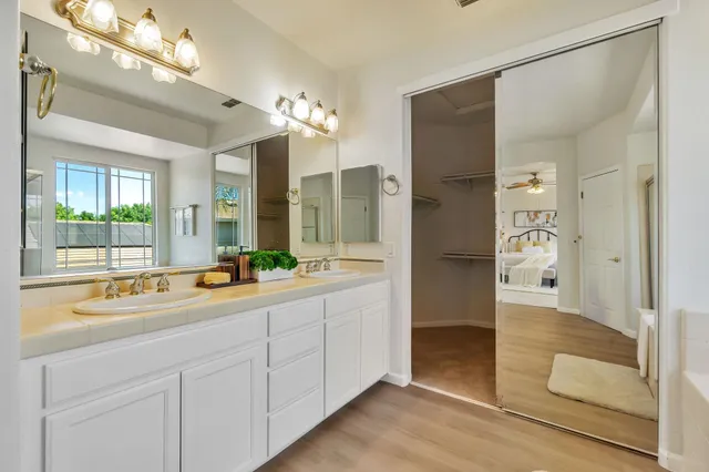 a bathroom with a sink mirror and a shower