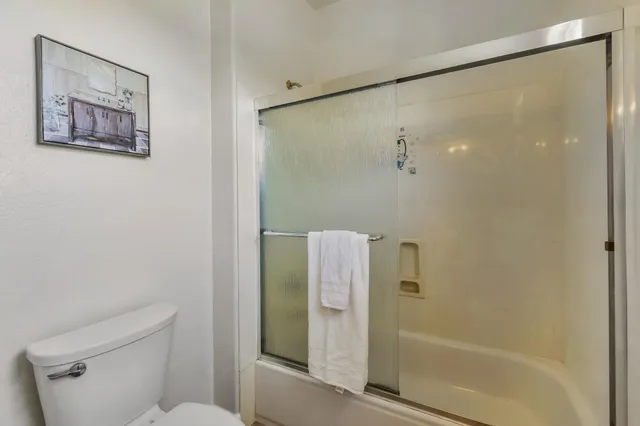 a bathroom with a toilet a sink and a mirror