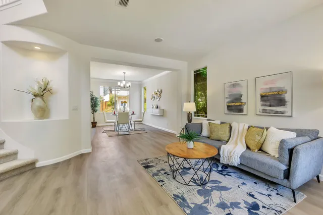 a living room with furniture and wooden floor