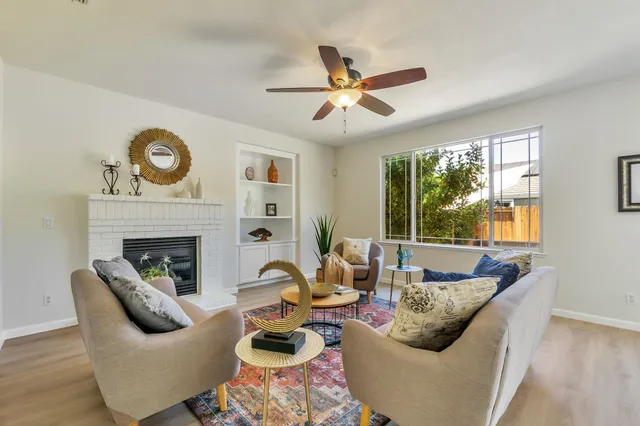 a living room with furniture and a fireplace