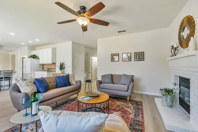 a living room with furniture and a fireplace