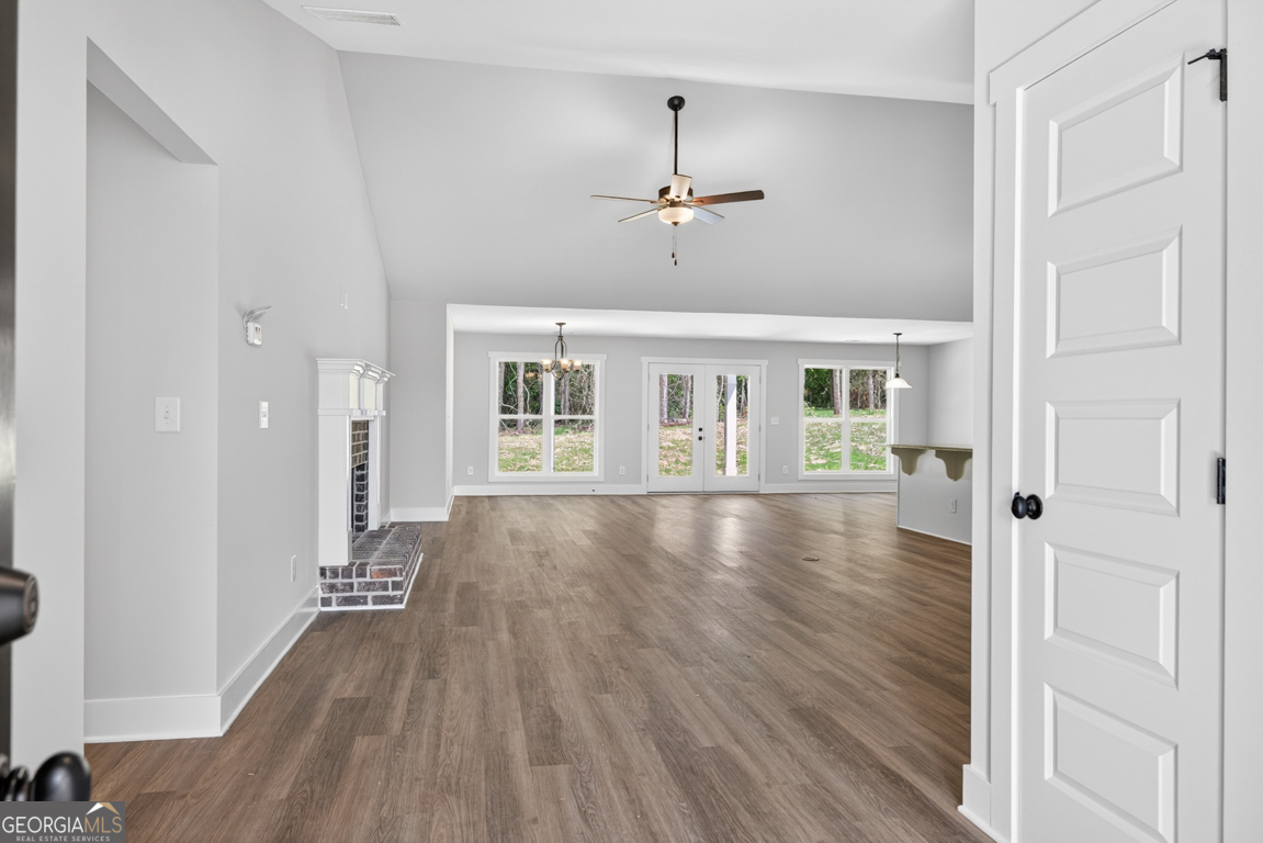 206 Airport Road, Unit 11 Canon, GA 30520 - Photo 5 of 34 a view of an empty room with wooden floor and a window