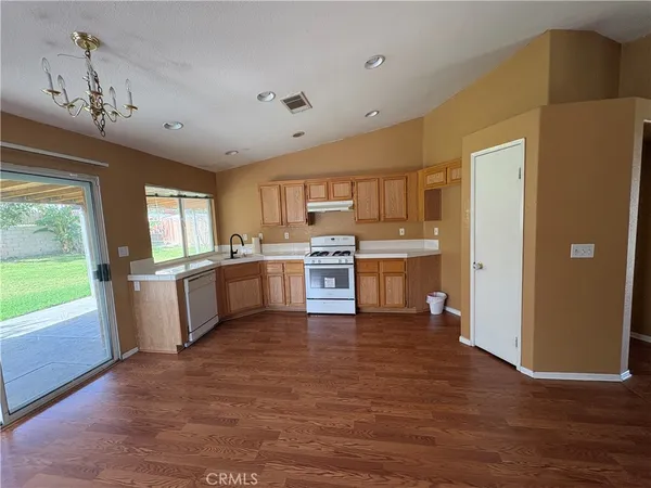 a large kitchen with kitchen island a large counter space a sink appliances and cabinets