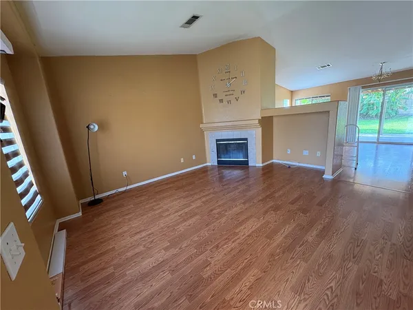 wooden floor in an empty room with a fireplace