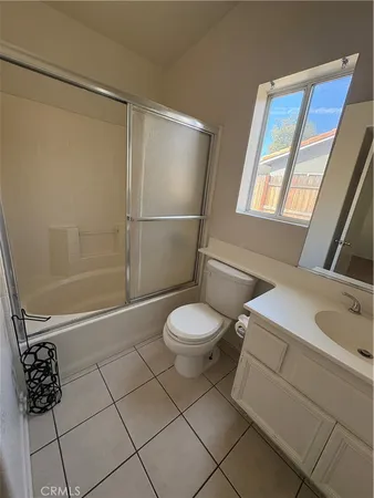 a bathroom with a granite countertop sink toilet a mirror and shower