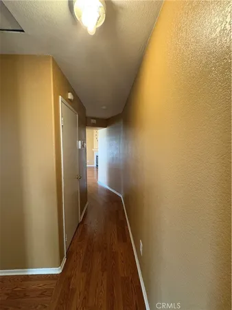 a view of hallway with wooden floor