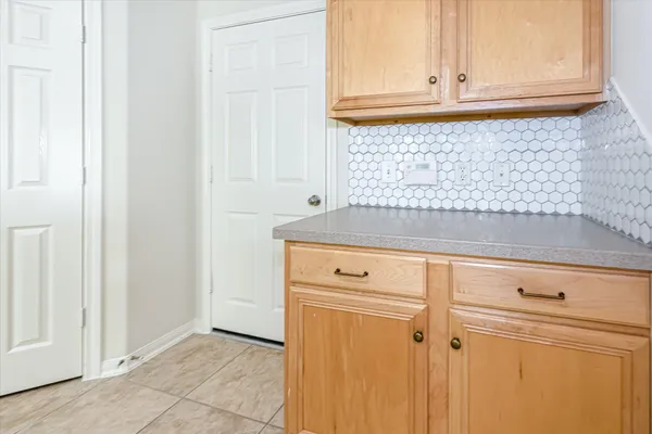 a view of a kitchen with white cabinets