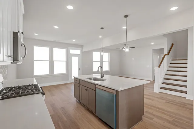 a kitchen with a sink appliances and cabinets