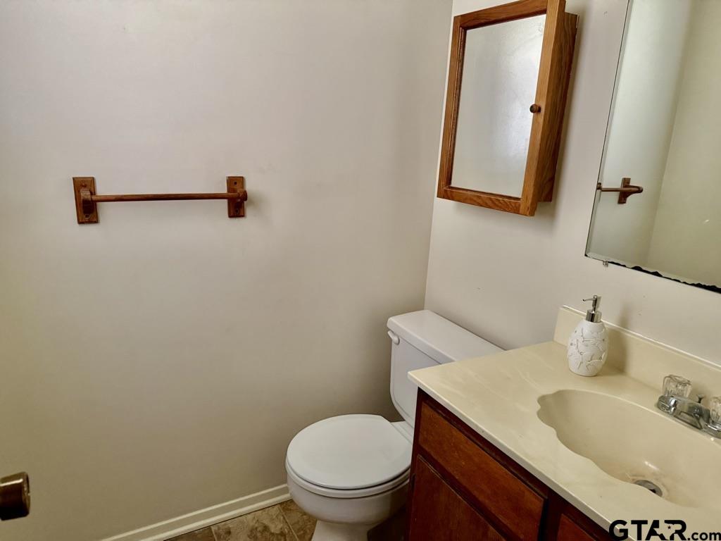 1102 Chad Whitehouse, TX 75791 - Photo 15 of 16 a bathroom with a toilet sink and mirror