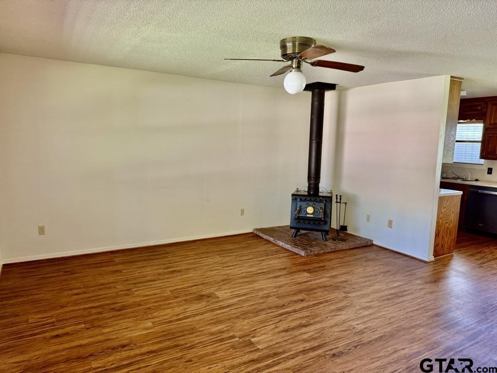 1102 Chad Whitehouse, TX 75791 - Photo 2 of 16 a view of a room with wooden floor and a chandelier