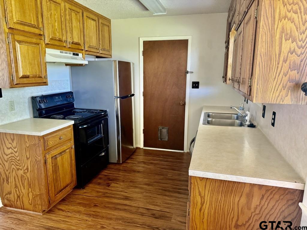 1102 Chad Whitehouse, TX 75791 - Photo 9 of 16 a kitchen with stainless steel appliances granite countertop a refrigerator a stove and a wooden cabinets