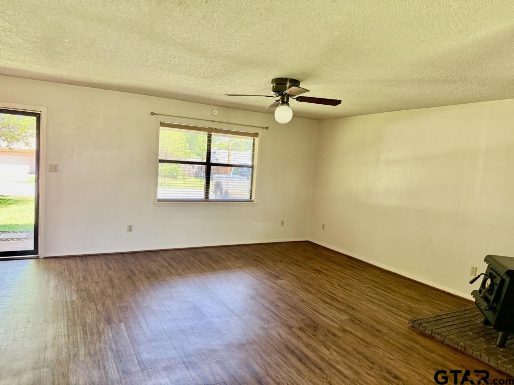 1102 Chad Whitehouse, TX 75791 - Photo 10 of 16 an empty room with a wooden floor and windows