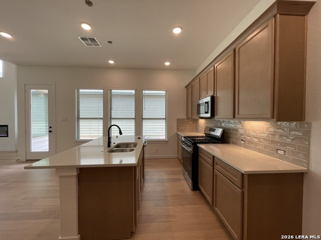 9431 Hidden Stone Schertz, TX 78154 - Photo 9 of 30 a kitchen with stainless steel appliances granite countertop a sink stove and refrigerator