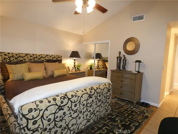 a bed room with a bed and a chandelier
