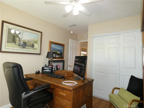 a view of a workspace with furniture and a flat screen tv