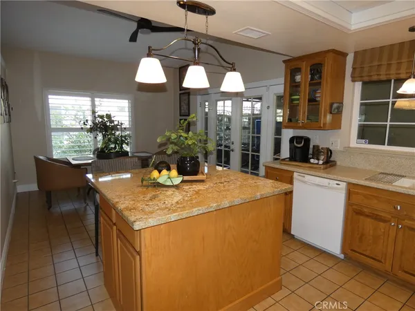 a kitchen with stainless steel appliances granite countertop a sink and a refrigerator