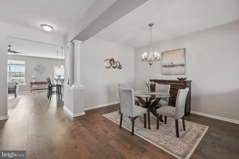a view of a dining room with furniture wooden floor and a chandelier