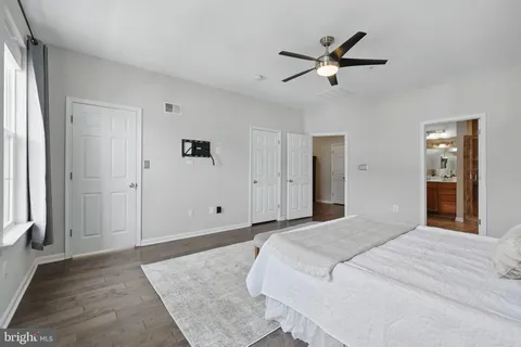 a bedroom with a large bed and a chandelier