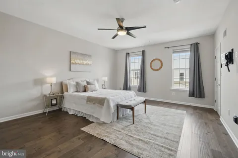 a spacious bedroom with a bed and a chandelier