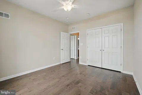 a view of an empty room with a ceiling fan