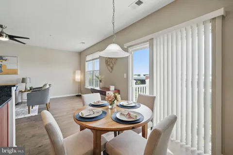 a dining room with furniture and wooden floor