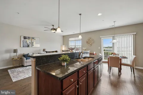 a kitchen with a stove kitchen island furniture and wooden floor