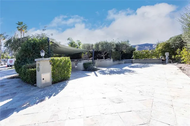 a view of a patio with couches chairs and a stove