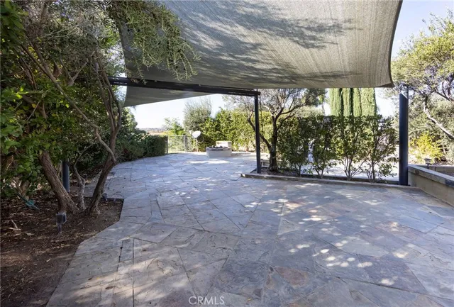 a view of a house with a tree and plants