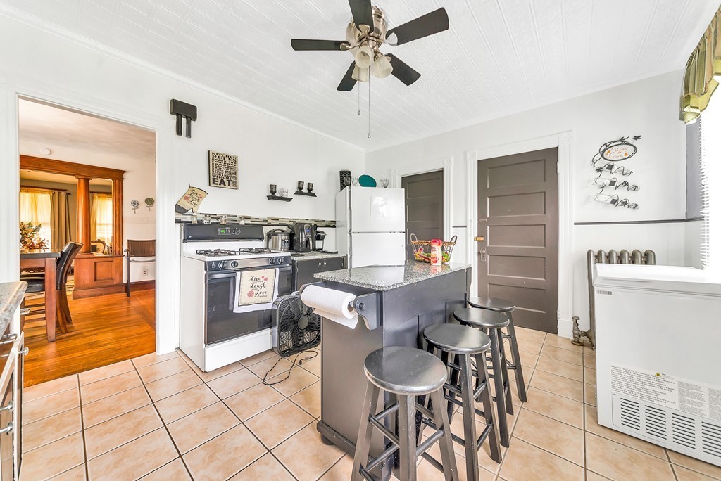 553 White Street Springfield, MA 01108 - Photo 9 of 25 a kitchen with a table chairs refrigerator and cabinets