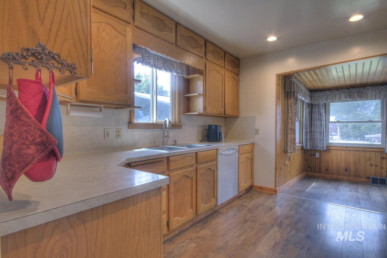 351 West Main Street South Vale, OR 97918 - Photo 1 of 33 Kitchen featuring wood-finish cabinetry, light-toned countertops, a double basin sink, and recessed lighting
