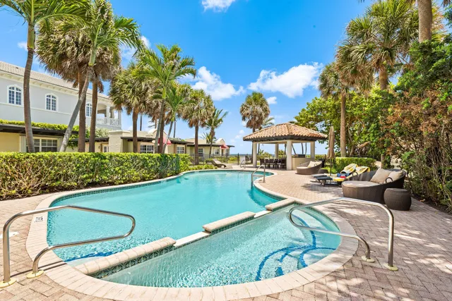 a swimming pool with outdoor seating and yard
