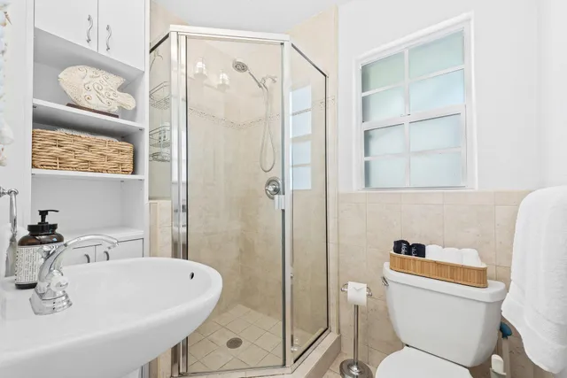 a bathroom with a sink toilet and shower